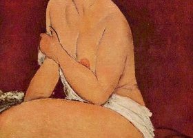 إمرأة عارية تجلس على أريكة